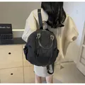 Puffy black nylon backpack for women with large capacity and side pockets for travel - Black