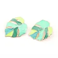 Golden monstera leaf stud earrings with green enamel inlay on a clean white background - Cyan