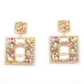 Detailed close-up of geometric gold alloy earrings with multicolored faceted crystals - Rainbow