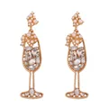 Macro detail of wine glass shaped earrings with pearls and sparkling rhinestones - White