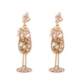 Macro view of vintage wine glass earrings with amber rhinestones and white pearls - Gold