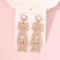 Detailed view of MAMA letter earrings featuring gold plating, pearls and sparkling rhinestones - Creamy White Pearl Top
