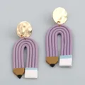 Creative pencil shaped polymer clay earrings with gold metallic discs on light gray background - Purple