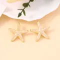 Elegant gold-edged starfish earrings with pearl white enamel and fine golden beads - Milky White