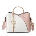 Pink and white color-block bucket bag with gold circular handle and heart tassel detail - Pink