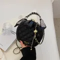 Black quilted circular crossbody bag with silk scarf handle and gold chain strap - Black