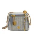 Light blue tweed bucket bag with gold chain strap and metal flower detail on white background - Light Blue
