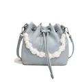 Light blue drawstring bucket bag with white bead handle and crossbody strap - Blue