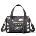 Close-up of gothic skull print handbag featuring metallic zippers and gold rivet details - Red