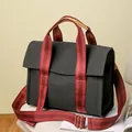 Bolso bandolera de lona negra con asas de rayas rojas y negras y herrajes dorados - Negro