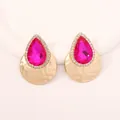 Detailed view of teardrop pink stone earrings with hammered golden metal texture - Magenta
