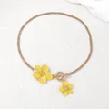 Detailed view of gold snake chain with yellow flower pendants and metal OT clasp buckle - Necklace / Yellow