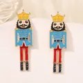 Nutcracker soldier earrings with colorful enamel finish on white display stand - Sky Blue