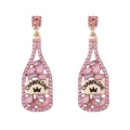 Detailed close-up of pink crystal champagne bottle earrings with gold champagne engraving - Pink