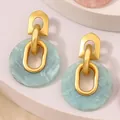 Pendientes geométricos en oro mate y resina jaspeada cian claro de estilo retro - Cian Redondo