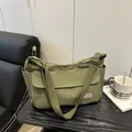 Olive green canvas messenger bag with adjustable shoulder strap for daily commuting - Green