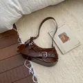 Dark brown faux leather underarm bag with decorative belts and cute dog charm - Coffee