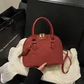 Brick red shell handbag with clover embossing and golden metal hardware in gift box - Red