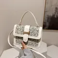 Chic beige crossbody bag with GK letter prints and golden metal buckle detail - White