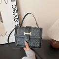 Grey monogram square crossbody bag with black leather trim and gold metal clasp - Black