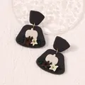 Handmade clay pumpkin drop earrings with floral accents for autumn and Halloween style - Black
