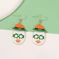 Detail of St. Patrick's Day hook earrings featuring face motif with shamrock glasses - White Flower Eyes