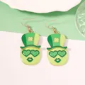 Macro detail of St. Patrick's Day earrings with green top hat face and heart sunglasses - Green Heart Eyes