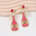 Creative pink champagne bottle earrings with pearls and glitter details for women - Pink