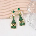 Green champagne bottle drop earrings with crown label and pearl bubbles design - Green