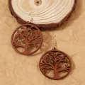 Handcrafted wooden Tree of Life dangle earrings with golden metal hooks on wood background - Brown