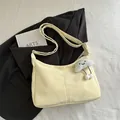 Minimalist light yellow half-moon hobo bag with a cloud charm on a soft fabric surface - With Pendant / Yellow
