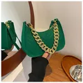 Detail of green felt baguette bag with V-shaped quilting and chunky gold chain strap - Green