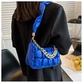 Detail of bright blue quilted puffer shoulder bag with gold chain and ruched strap - Blue
