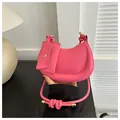 Detail of bright pink crescent bag with knot strap and matching small card pouch - Pink
