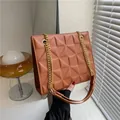 Brown quilted crossbody bag with golden chain strap and 3D triangular embossed texture - Brown