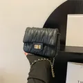 Chic black quilted crossbody bag with gold chain strap and elegant metallic turn-lock - Black