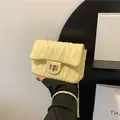 Quilted light yellow shoulder bag with gold chain strap and metal swivel lock - Yellow