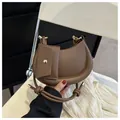 Dark brown crescent moon shoulder bag with padded edges and metal buckle detail - Dark Brown