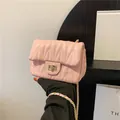Pink quilted shoulder bag with V-shaped stitching, gold clasp, and chain strap - Pink
