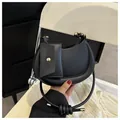 Chic black crescent shoulder bag in smooth leather with a unique knotted round handle - Black