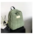 Detail of light green quilted nylon backpack with soft padded wave texture and handles - Green