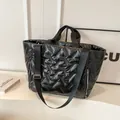 Fashionable black quilted puffer tote bag with glossy finish and wide shoulder strap - Black