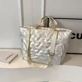 Quilted silver tote bag with metallic finish and wide adjustable shoulder strap - Off-white