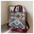 Detail of bohemian canvas tote with ethnic geometric patterns and brown leather handles - Brown Large