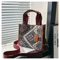 Detail of woven jacquard tote bag with burgundy straps and golden twist-lock closure - Brown Small