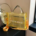 Transparent yellow mesh tote bag with white TOTE BAG text and orange strap - Yellow