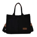Large black corduroy tote bag with dual front pockets and brown leather handle accents - Black
