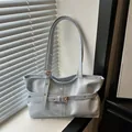 Detail shot of light blue leather shoulder bag with buckle and metal eyelet accents - Blue