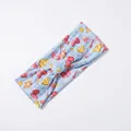 Close-up of elastic yoga headband with light blue fabric and Peanuts cartoon print - Blue