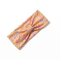 Detail of a yellow stretch headband with pink clouds, stars and knots for fitness - Yellow